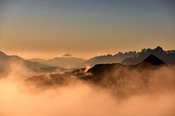 istock Mountain peaks during sunrise in the clouds 1726087695