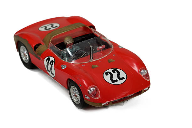 A red toy racing car with a driver on a white background
