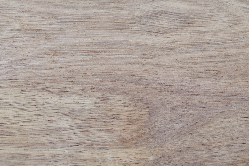 A beautiful light wooden natural kitchen table top background texture, with shades and shadows, background ideal for product placement, with a large copy space area