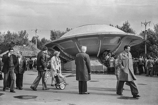 Moscow, Russia - October 1, 2023: UFO and its visitors in '60 years of Soviet cinema' exhibition in VDNKh in September 1979. Black and white 35mm film scan