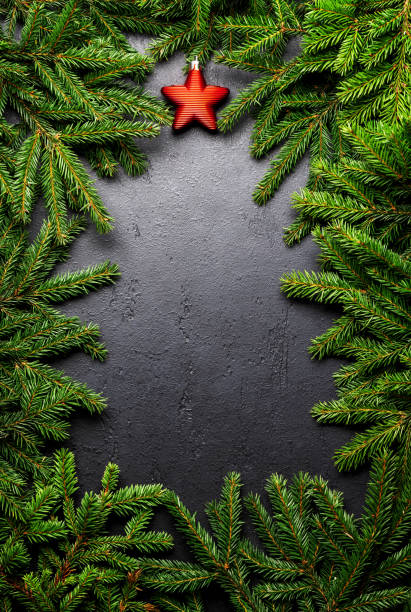 istock Christmas fir tree branch frame over stone 1726167661