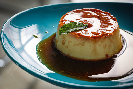 Bulgarian dessert resembling flan and crème brûlée, with a touch of Balkan and Mediterranean cuisine, garnished with a small mint leaf.