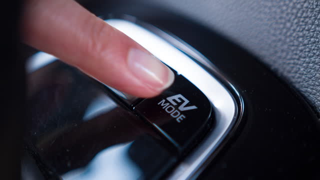 Pressing EV mode button in modern hybrid car