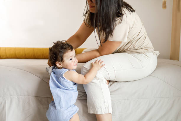 istock Woman fixing  toddler's clothing 1726190234