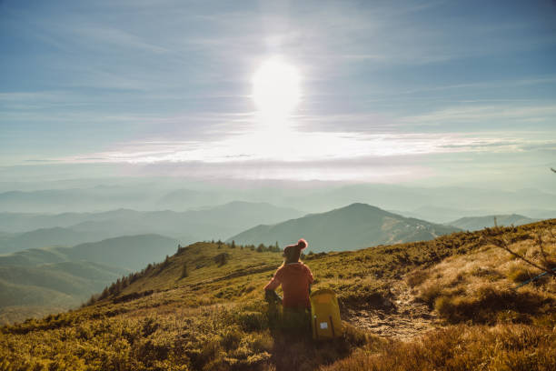 istock Female hiker resting and enjoying the view from a mountain peak 1726191922