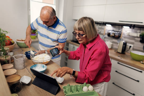 istock Senior couple making an apple pie in modern kitchen 1726200611