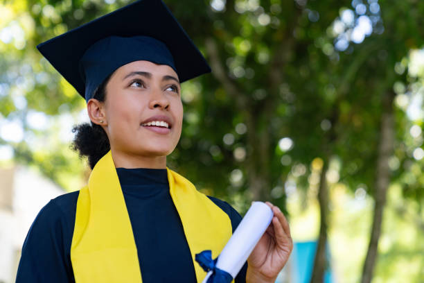 istock Proud graduate holding her diploma on her graduation day 1726208235