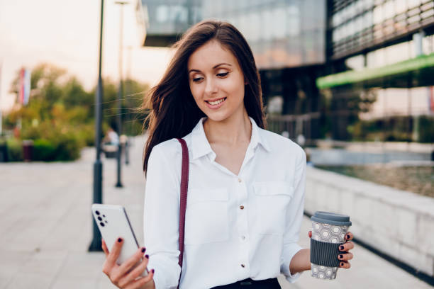 istock Business woman holding smartphone and going to work 1726209927