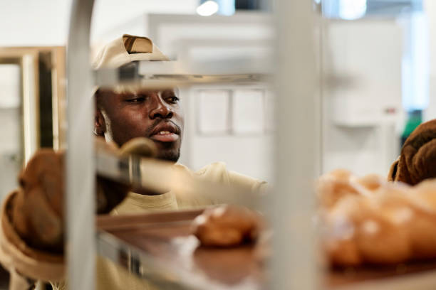 African American young man in bakery kitchen