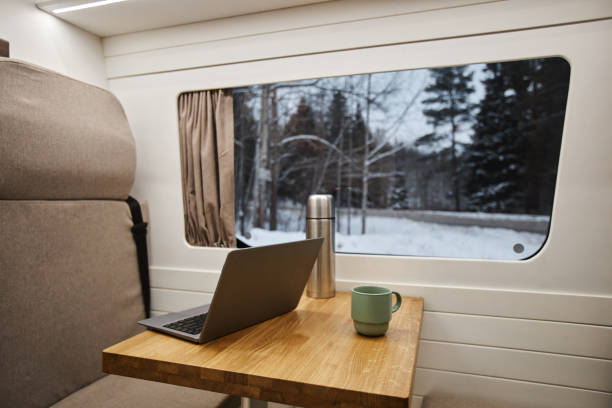 istock Close up of open laptop on table by windows in trailer van interior 1726223166