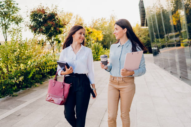 istock Two business women talking while walking outdoors 1726225048