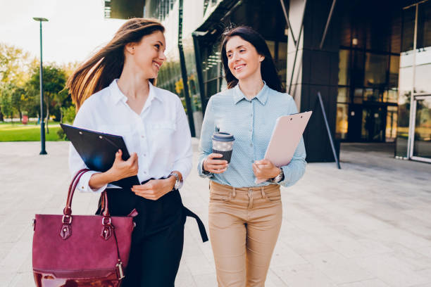istock Two business women talking while walking outdoors 1726227320