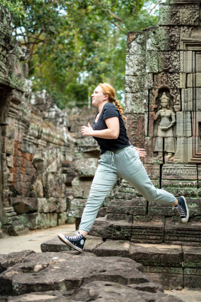 istock Young Redhead Girl Exploring Angkor Wat, Cambodia 1726232034