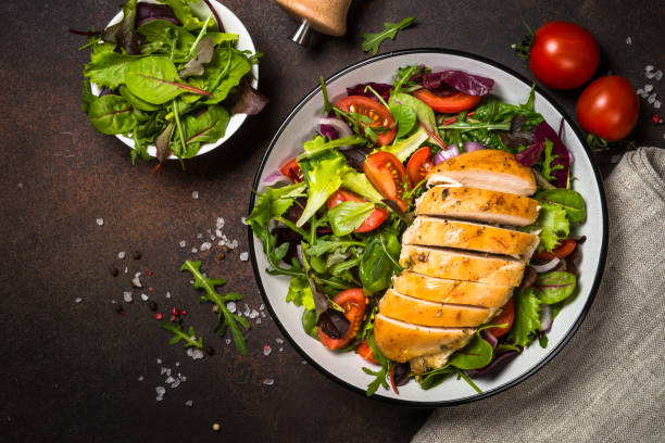 istock Green salad with baked chicken breast at kitchen table. 1726236718