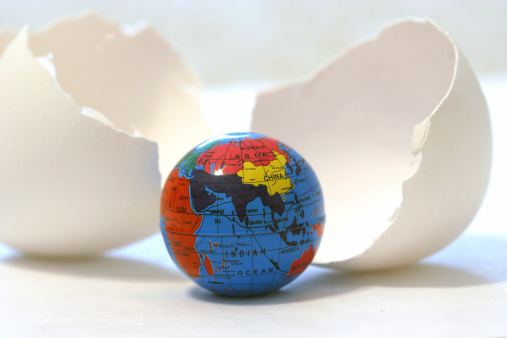 a globe hatching from an egg