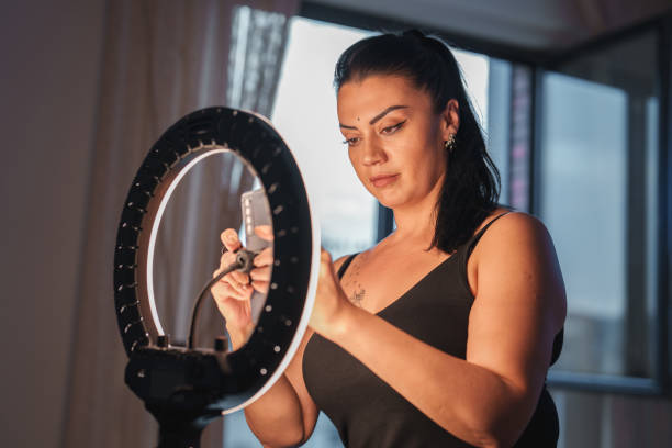 istock Woman shooting video for social media with ring light and mobile phone. 1726244708
