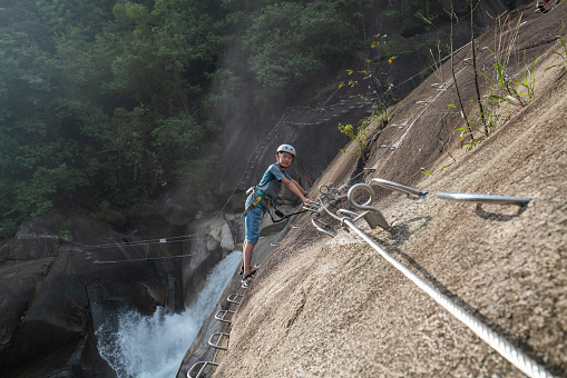 Young boy exploring at cliff