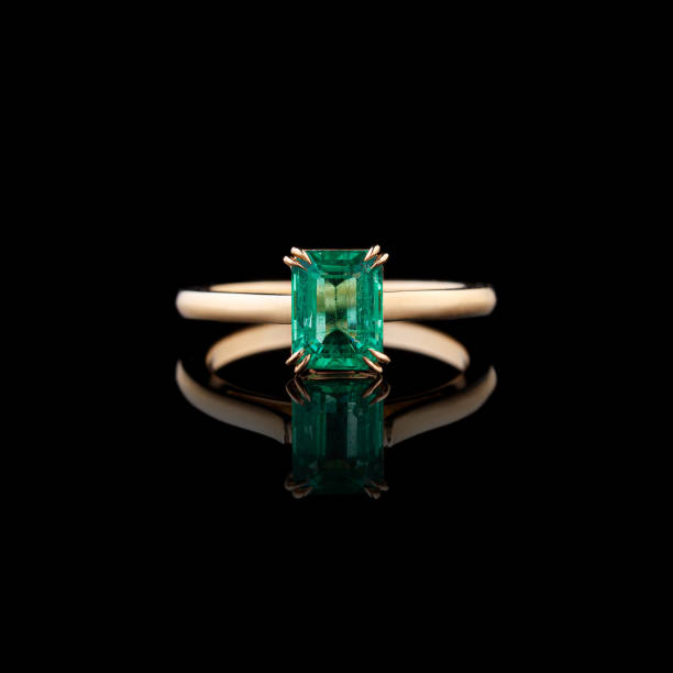 istock beautiful yellow gold ring with emerald on a black background 1726249493