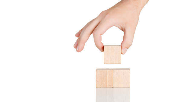 istock wooden cubes in the form of a pyramid with a hand on an isolate white background 1726250616