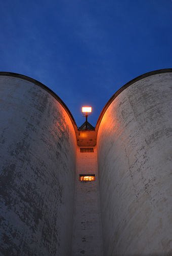 A view of a sugar silo at sunset, shot from an extreme perspective.