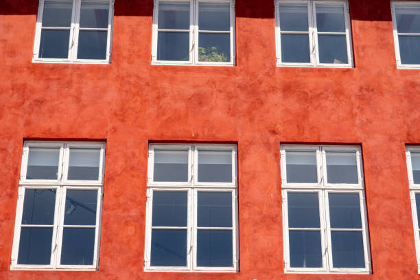 Windows in red house facade as background or texture. High quality photo