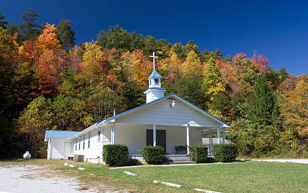 Rura church in autumn Small country church in Georgia with fall foliage in the background. baptist stock pictures, royalty-free photos & images