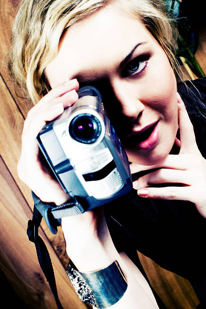 istock woman with video camera 172625570