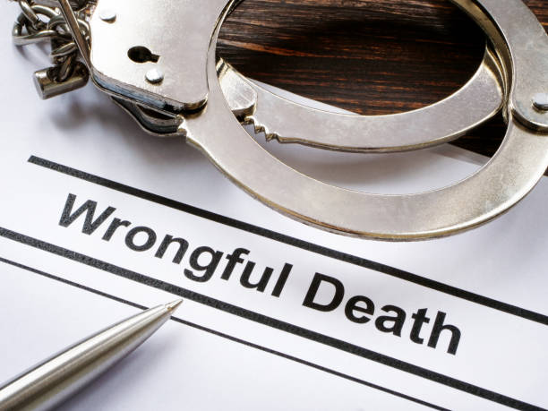 Documents about Wrongful death and metal handcuffs. Documents about Wrongful death and handcuffs. Wrongful Death Attorney stock pictures, royalty-free photos & images