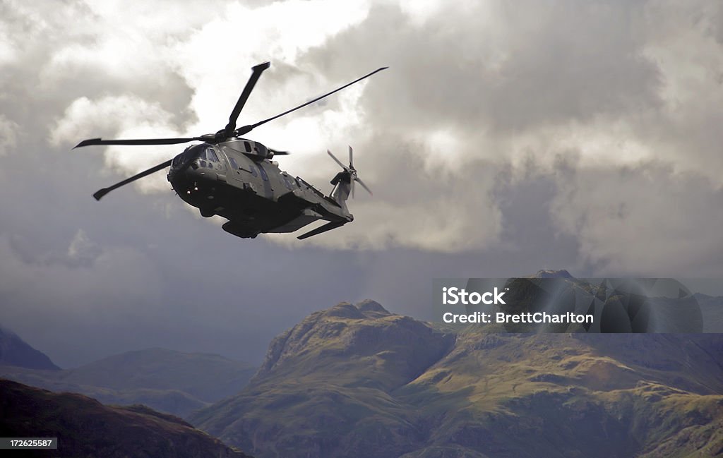 Merlin Helicopter Patroling Cumbrian Mountains Low level RAF Merlin helicopter hugs valleys in the lake district mountains during poor weather exercise Military Helicopter Stock Photo