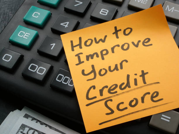 Memo stick with How to improve your credit score inscription on the calculator. stock photo