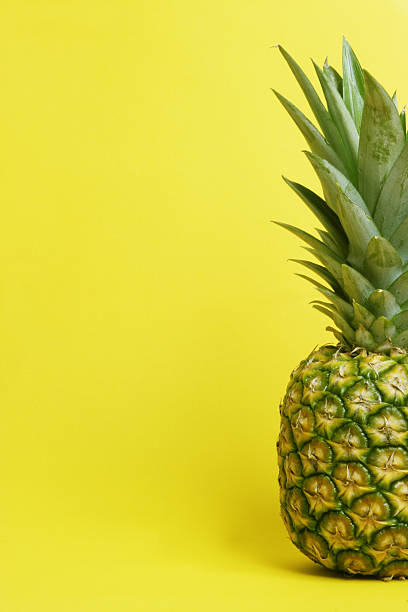 pineapple on yellow too stock photo