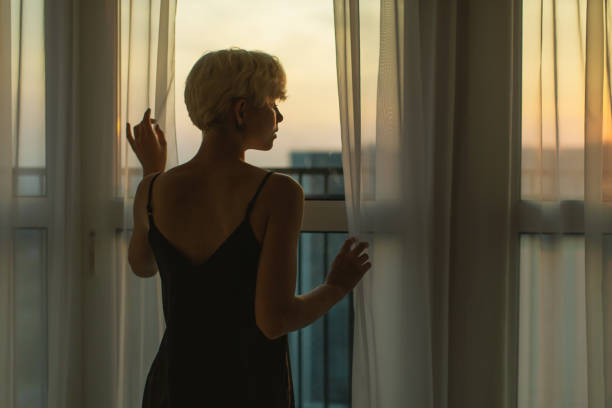 istock Woman looking out the window. Morning 1726259815