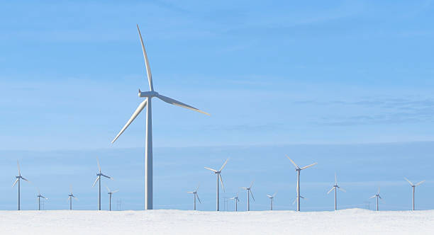 Windmills and wind turbines in winter snow stock photo