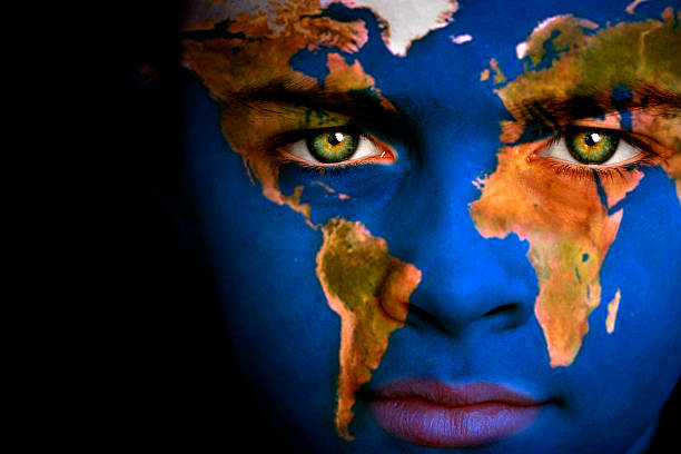 Earth boy Portrait of a boy with the map of the world painted on his face. body paint stock pictures, royalty-free photos & images