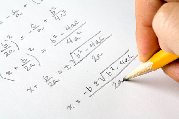 Hand writing algebra equations stock photo