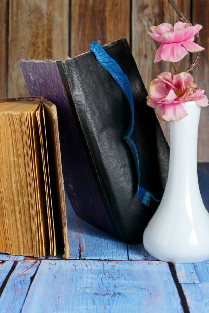 istock still life with artificial flowers and old books on the table 1726264351