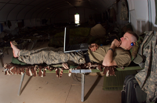 A U.S. Soldier relaxing on a cot prior to redeploying to the states.