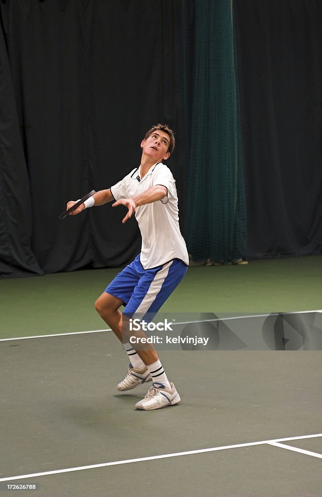 Indoor tennis match Young man playing tennis.  Lob - Sports Activity Stock Photo