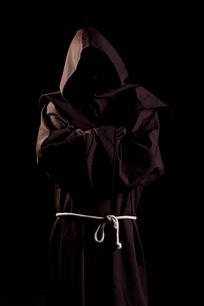 Monk Monk in dark room. Cloak, rope, hood. ceremonial robe stock pictures, royalty-free photos & images