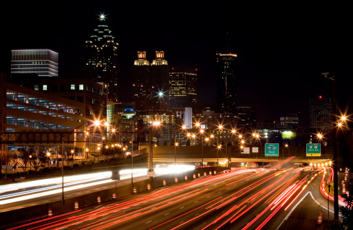 Long exposure shot of the Atlanta skyline at night with the downtown connector (I75/I85) in the foreground.