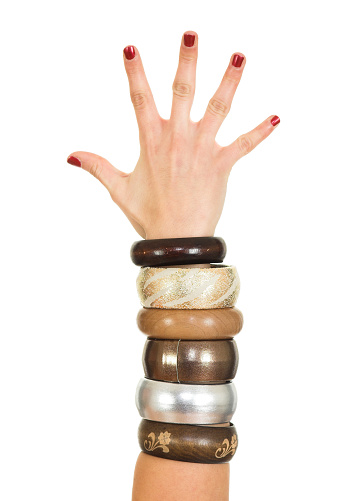 Different bracelets on woman's hand isolated on white background