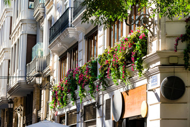 Old building facade with balcony full of flowers