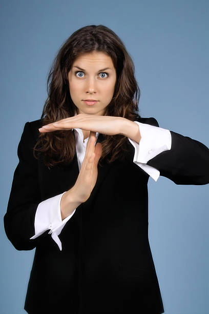 Time Out! Young business woman signaling for a time out. time out signal stock pictures, royalty-free photos & images