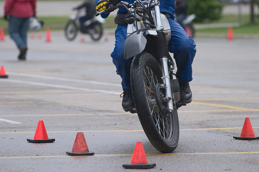 Close up of rider going through pylon course at motorcycle school.