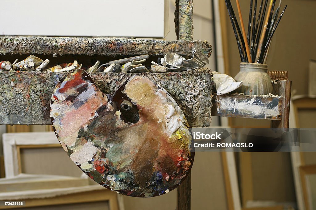 Classical palette with oil colors in the artists studio Classical palette with oil colors hanging on the easel Activity Stock Photo