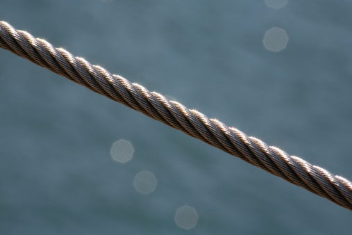 a steel cable against a watery background
