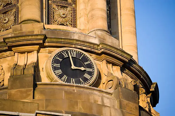 "The clock tower on an old Victorian building in the historic town of Saltaire, Yorkshire, England"