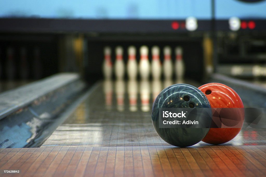 Bowling balls and pins "two bowling balls focused and at the end, the pins waiting for the shot (with some grain for the lights)" Bowling Alley Stock Photo