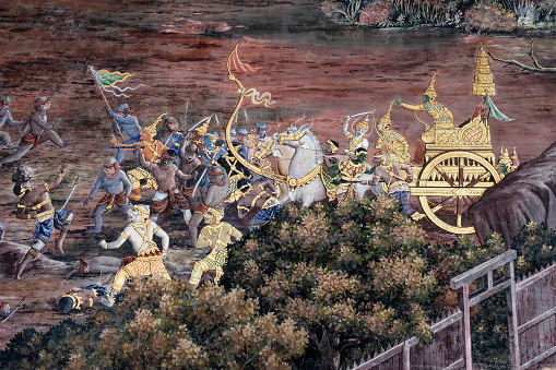 Bangkok, Thailand, December 27, 2018. Within a Thai temple, a traditional mural painting captures a fierce battle scene, portraying the mythical narratives of an ancient Indian epic.