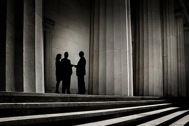 "Three people, silhouetted against a backdrop of power, shaking hands.To see more of my financial images click on the link below:"